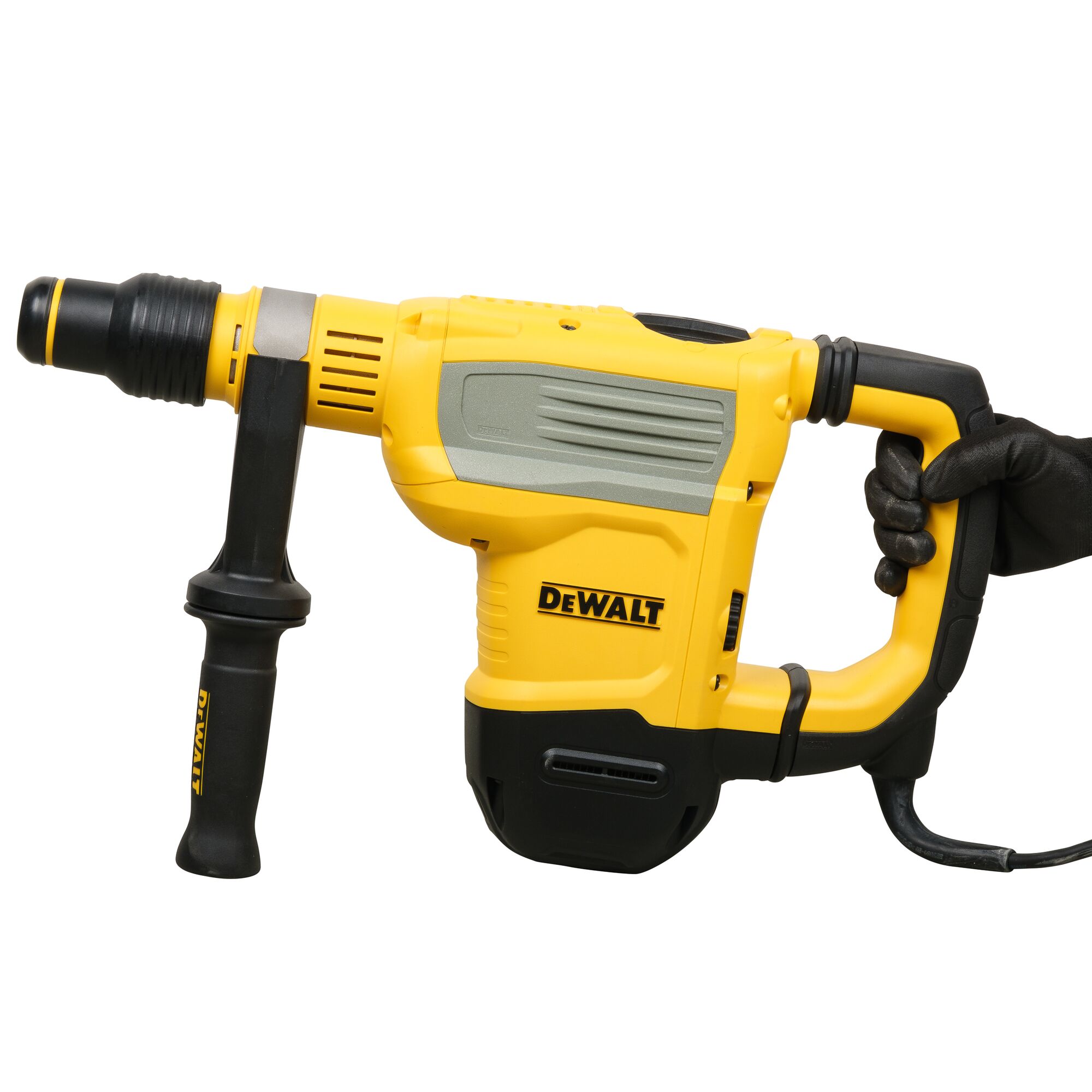 A yellow and black DEWALT rotary hammer drill being held by a gloved hand, with a side handle for added control, shown on a white background.