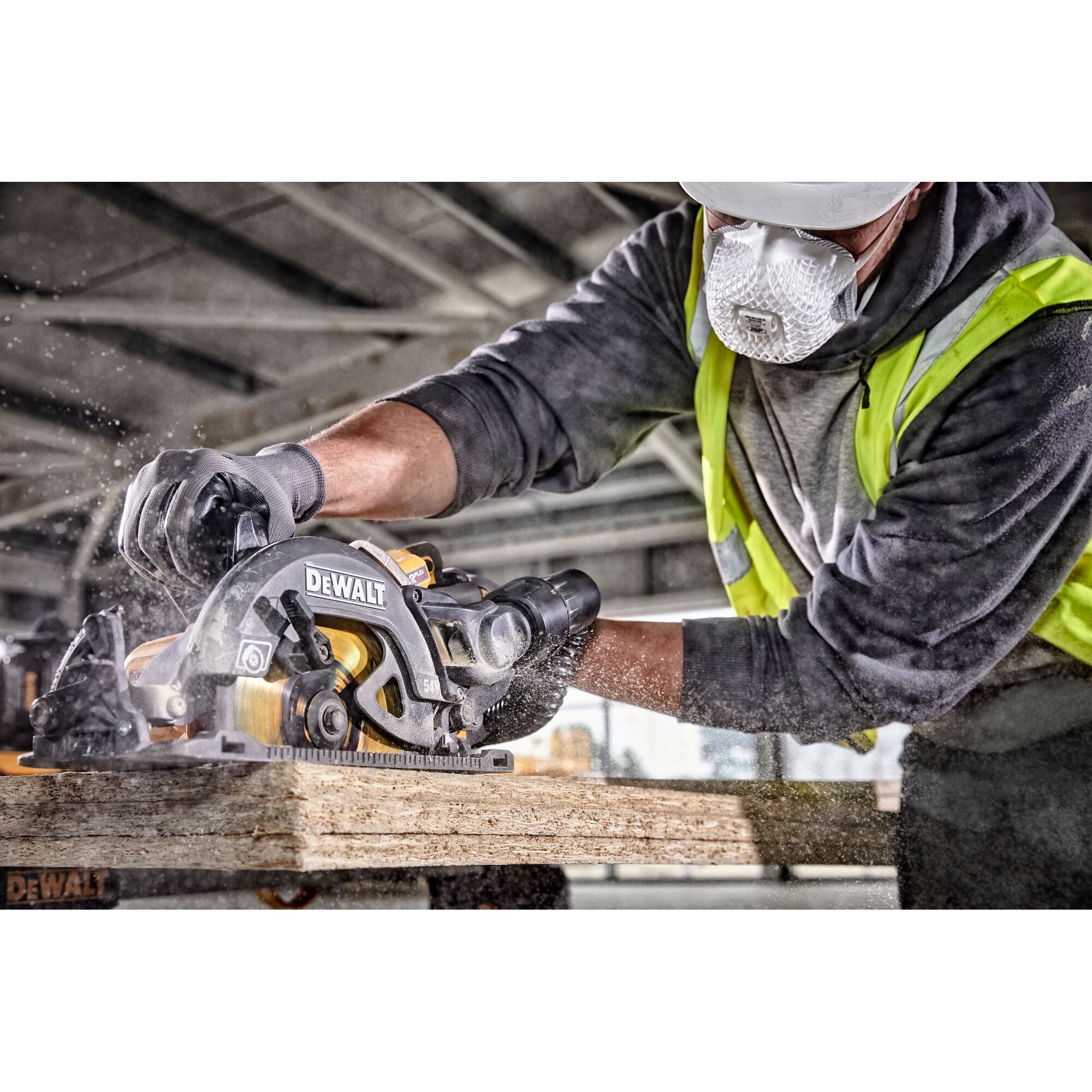 Worker uses DEWALT circular saw to cut wood, wearing safety gear and mask. Sawdust visible during cutting.