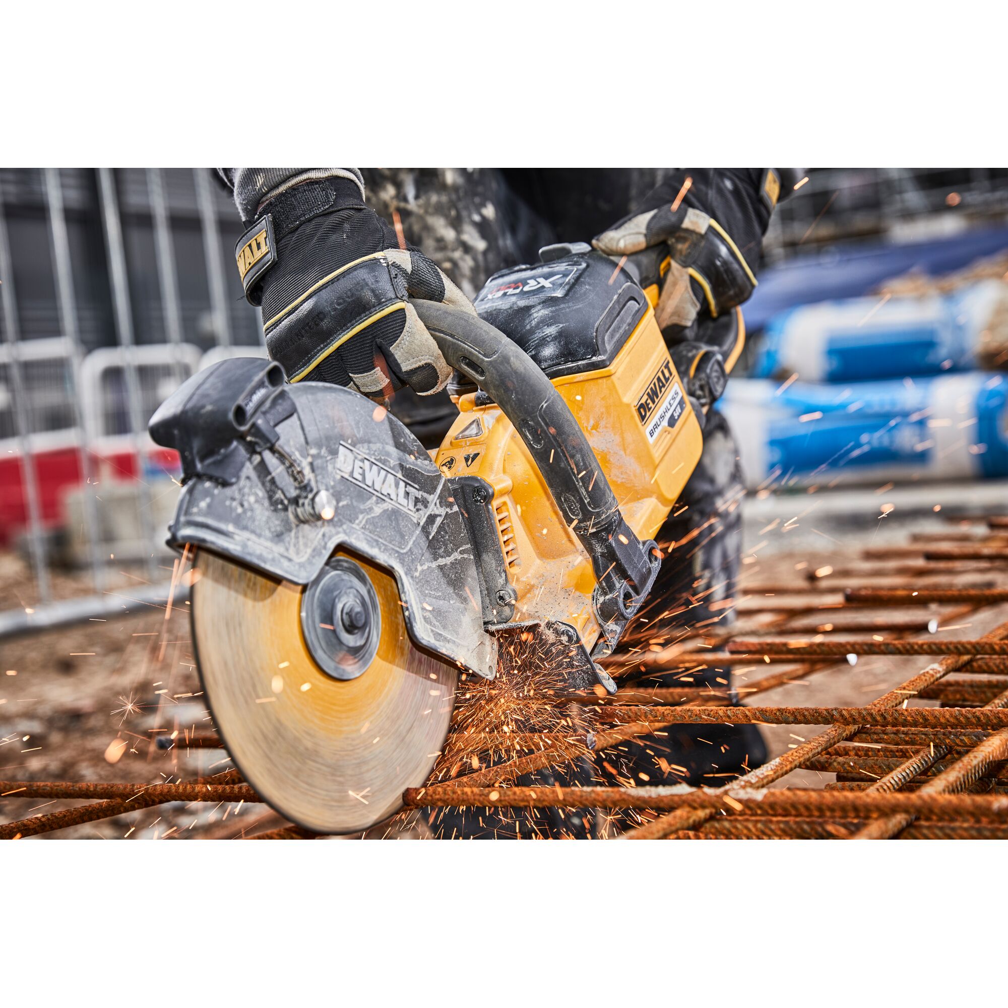DEWALT cutter slicing metal rebar at a construction site, sparks flying from the circular blade.