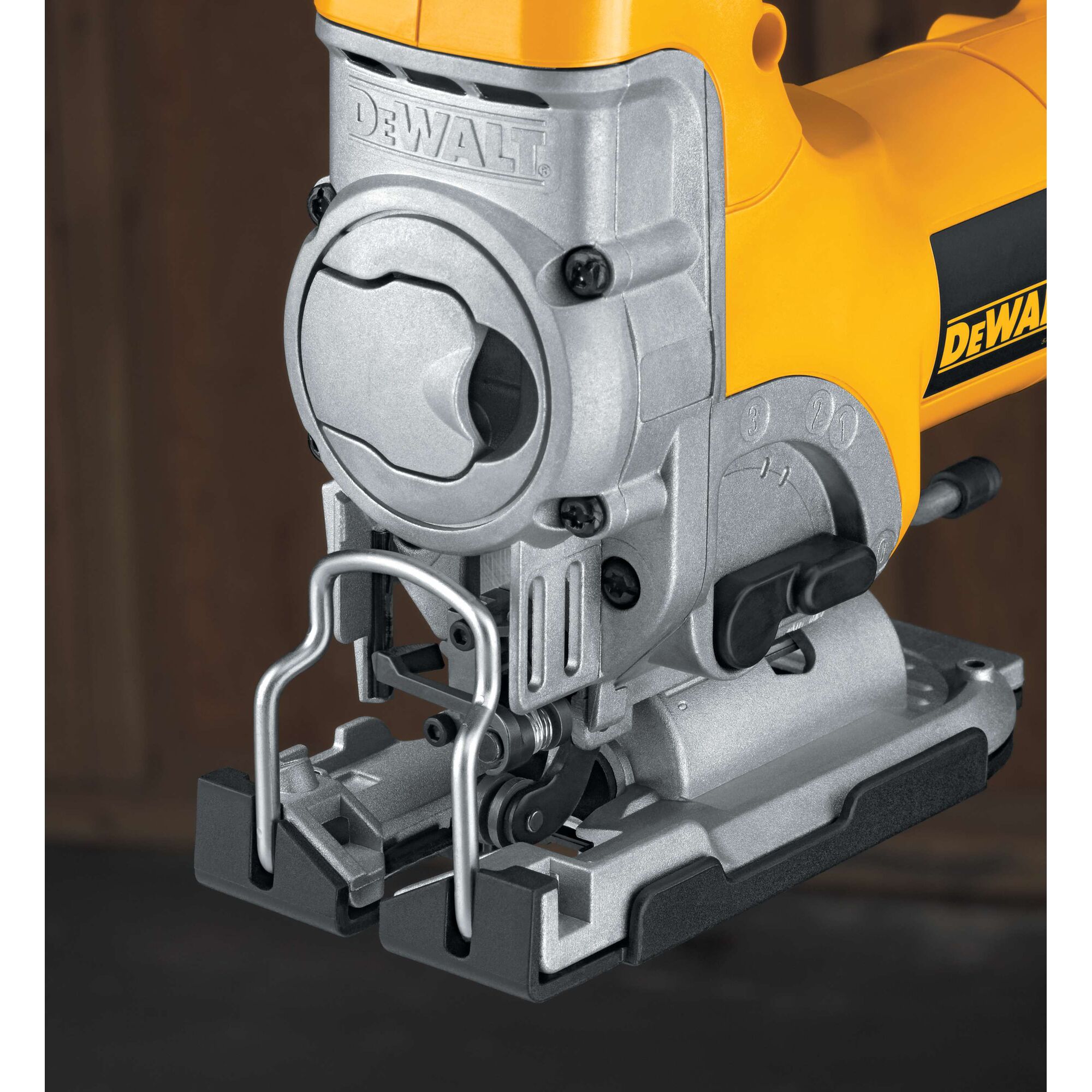 Close-up image of a DEWALT DW331K jigsaw, highlighting its metal base, blade guard, and yellow body. The photo focuses on the tool's front section and detailed components.