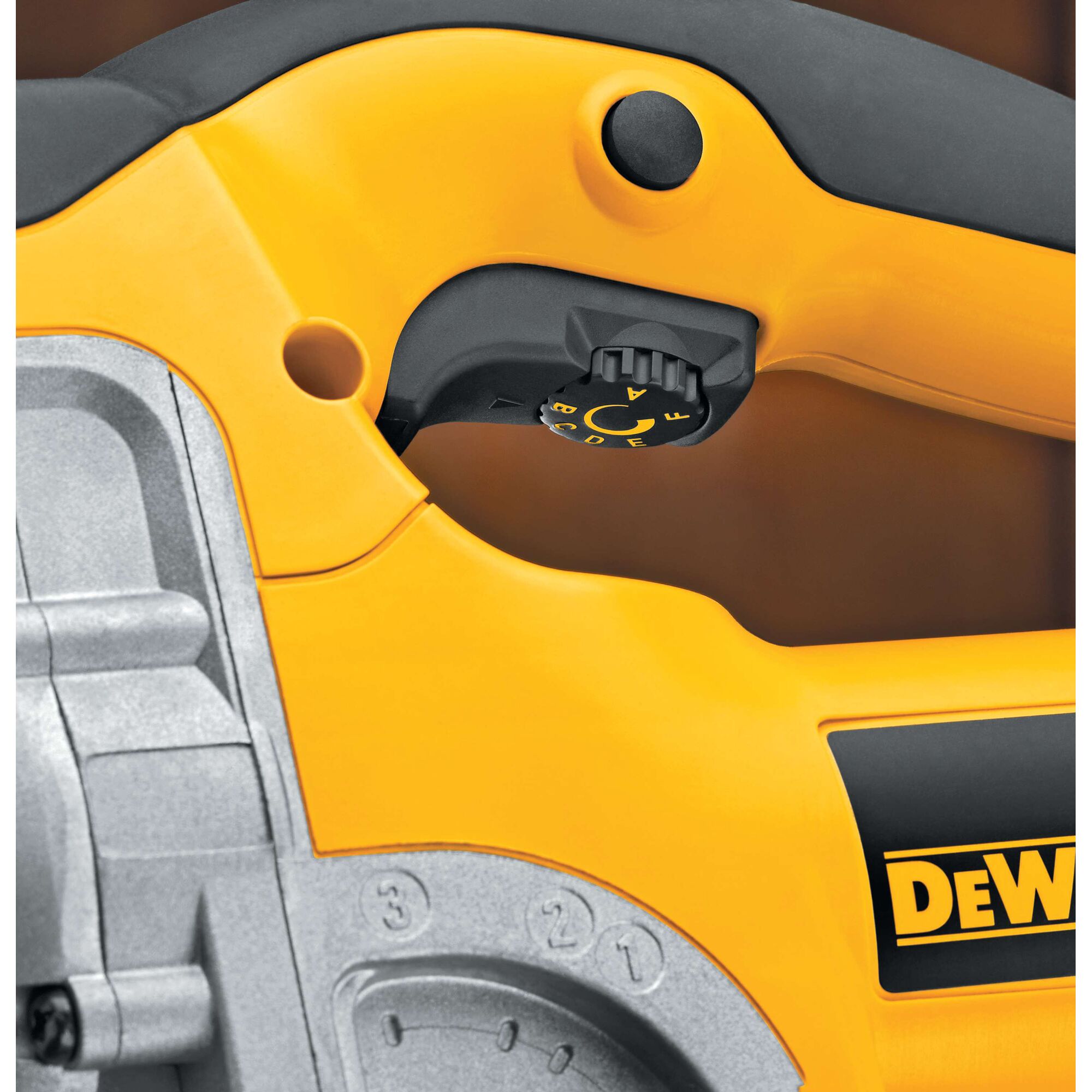Close-up photo of the handle and control dial of a yellow DEWALT power tool, featuring black and gray accents and labeled controls.